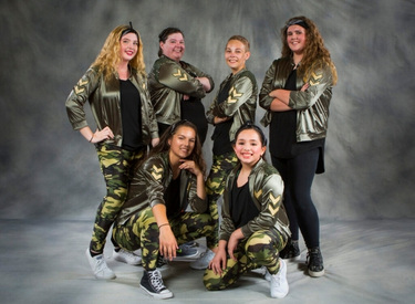 Hip hop dancers in recital costumes